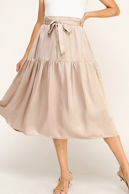 Beige skirt worn by a person on a white background